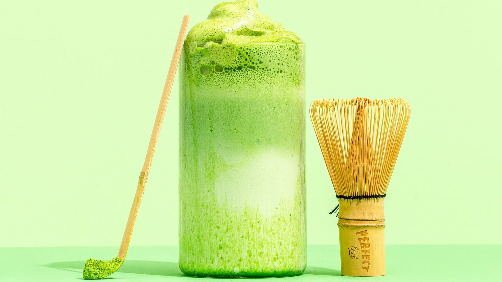 Matcha latte with traditional matcha bamboo whisk.