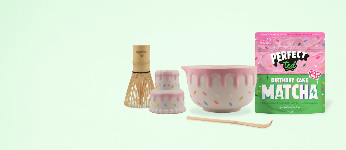 a bowl and a cake with a bamboo whisk