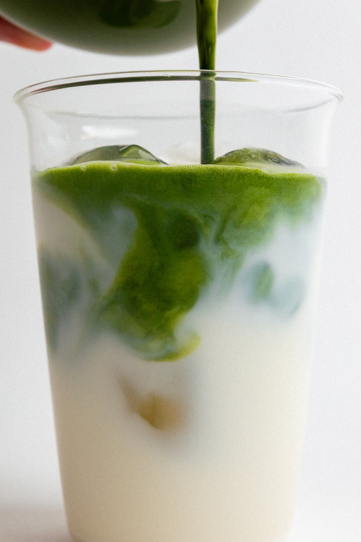 a glass with a straw and a drink