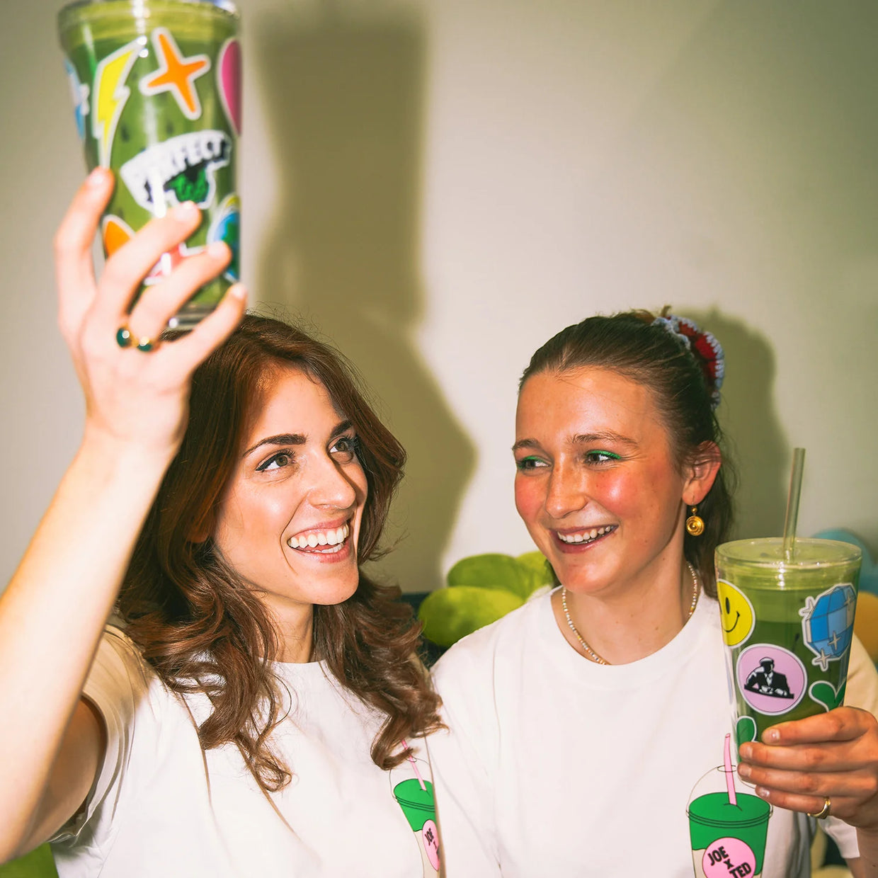Shani and Romy drinking matcha lattes from the to-go cups