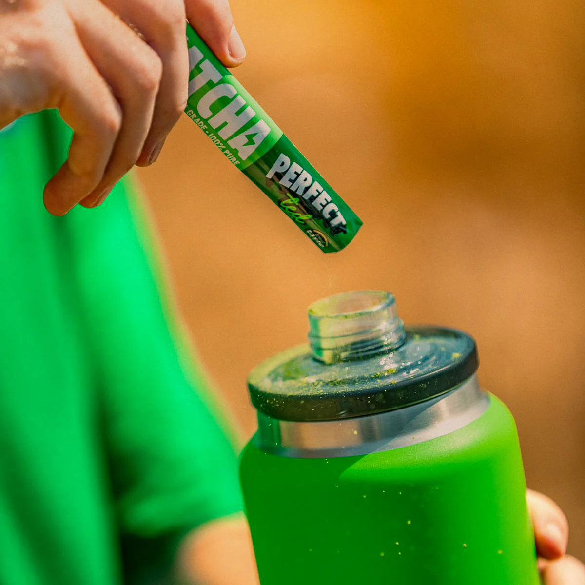 Hardest Geezer pouring a single serve matcha sachet into bottle