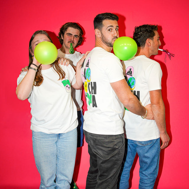 The PT team wearing colab t-shirts with baloons and party poppers.